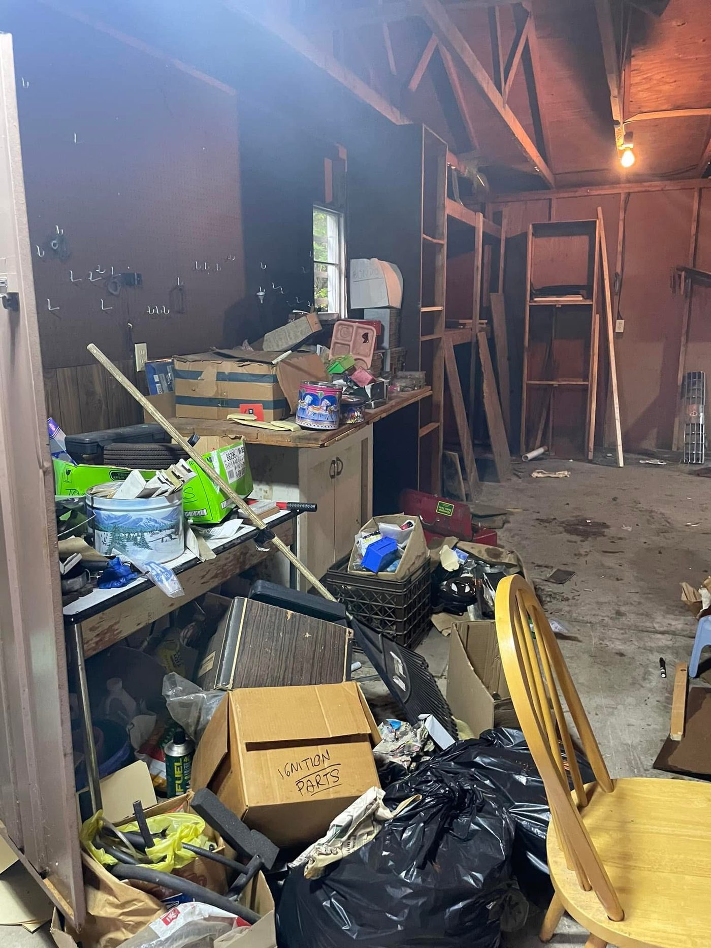 Garage workshop filled with boxes and belongings before a cleanout