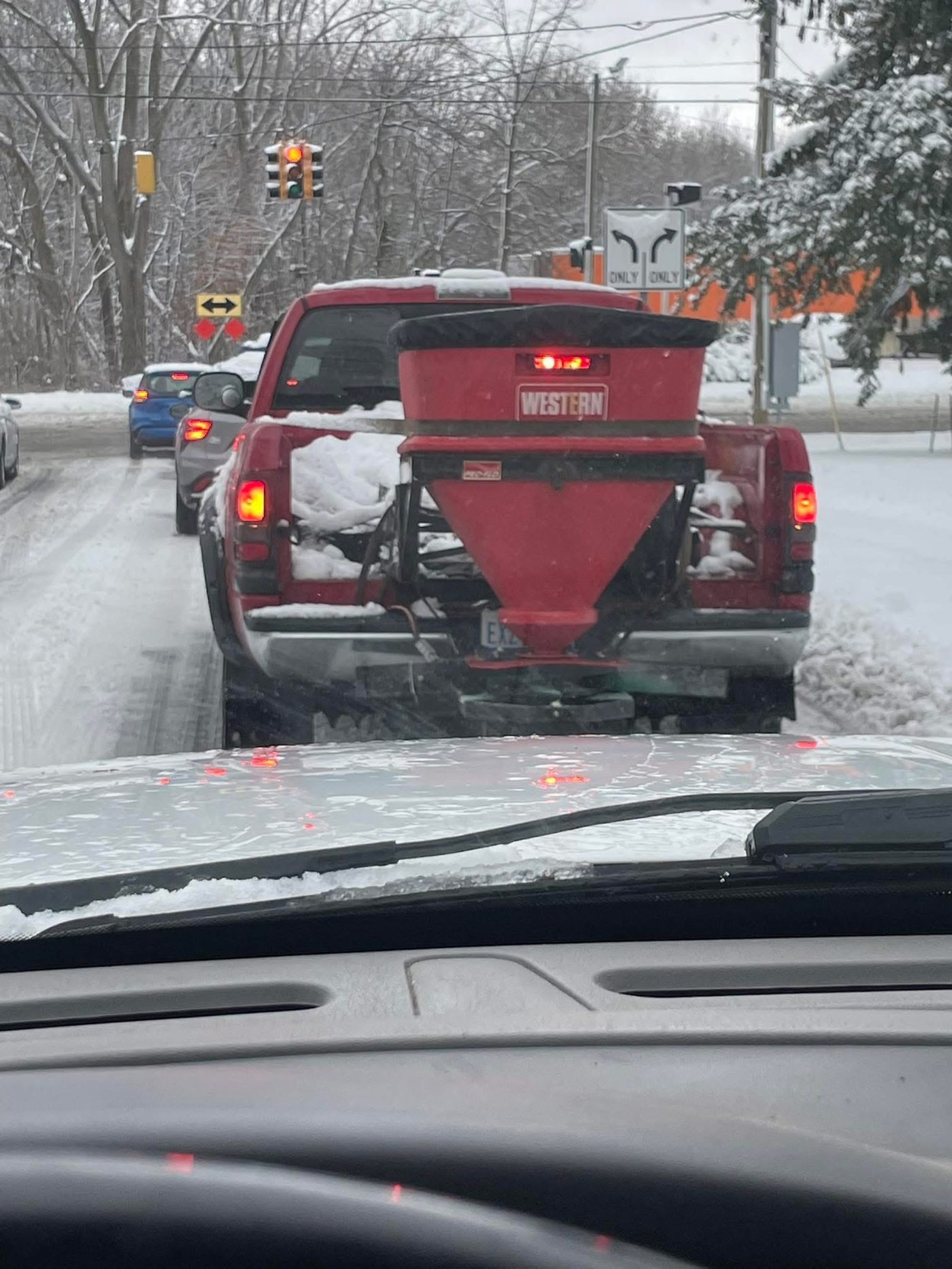 Truck equipped with a salt spreader working during a snow event